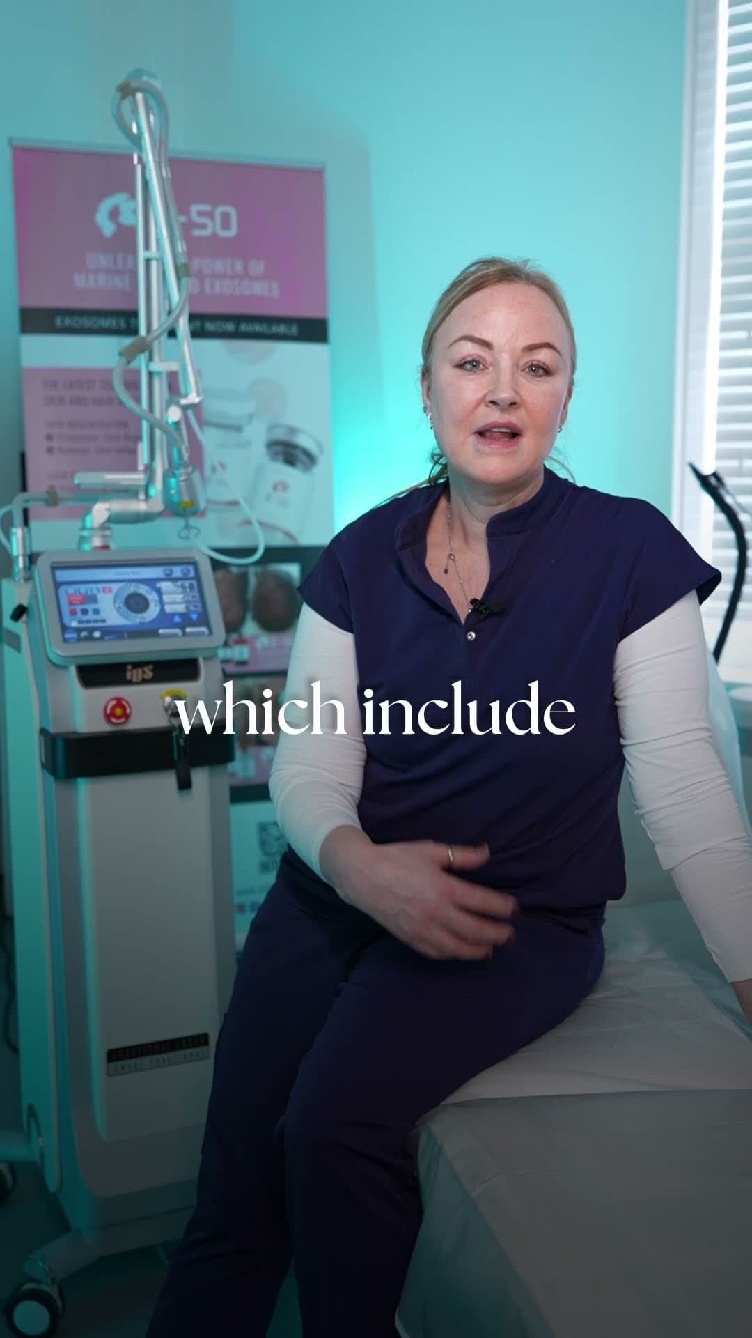 Clinician seated beside a CO2 laser machine explaining skin resurfacing