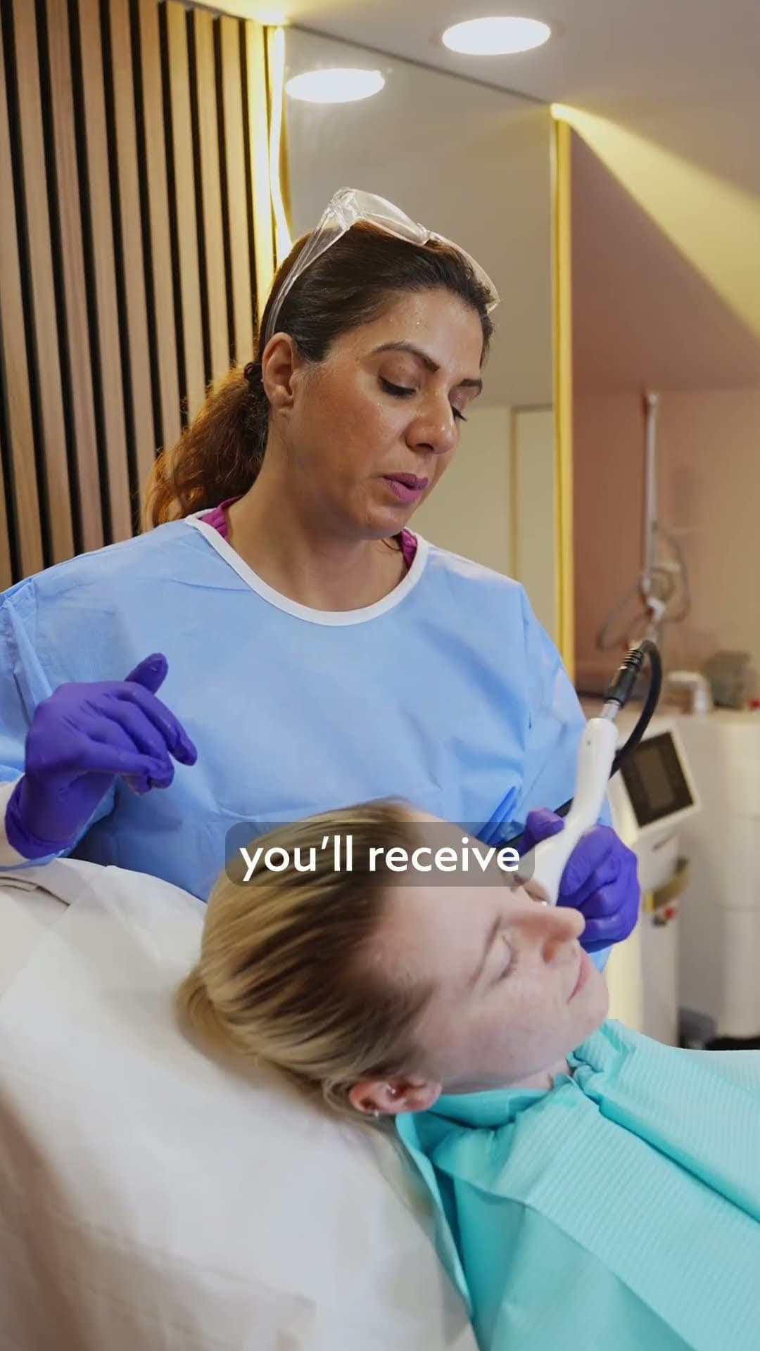 Practitioner giving a patient a dermal filler treatment in a clinic chair
